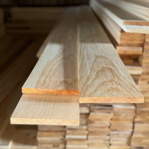 1x8 S4S clear lumber displayed in a lumber yard, showcasing smooth, finished surfaces ideal for residential and commercial projects.