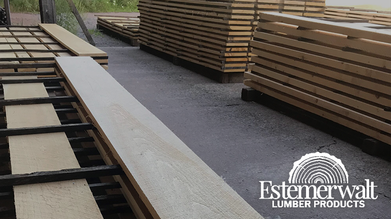 Lumber stacks at Estemerwalt Lumber Products in Honesdale, Pennsylvania, showcasing a variety of wood boards for construction and home projects.
